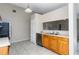 Kitchen featuring tile floors, sink, cabinets, dishwasher, and pass-through to the living room at 103 N Atlas Dr, Apopka, FL 32703