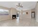 Spacious living room with tiled floors, a fireplace, a ceiling fan, and sliding glass doors to the outdoors at 103 N Atlas Dr, Apopka, FL 32703