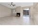 Inviting living room with a fireplace, tiled floors, a ceiling fan, and sliding glass doors to the backyard at 103 N Atlas Dr, Apopka, FL 32703