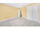 Bedroom features tiled floors, ceiling fan, and a closet with sliding doors at 109 Mcquigg Ave, Orlando, FL 32805