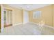 Bedroom features tiled floors, ceiling fan, and a closet with sliding doors at 109 Mcquigg Ave, Orlando, FL 32805