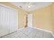 Bedroom features tiled floors, ceiling fan, and a closet with sliding doors at 109 Mcquigg Ave, Orlando, FL 32805