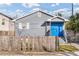 Charming home with a bright blue front door and wooden picket fence at 109 Mcquigg Ave, Orlando, FL 32805