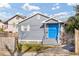 Charming home featuring a blue front door, wood fence, and manicured lawn at 109 Mcquigg Ave, Orlando, FL 32805