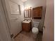 Cozy bathroom features a wood vanity, a built-in storage cabinet, and a standard toilet at 110 Kasey Dr, Orlando, FL 32807