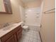 Bathroom featuring a single sink vanity, standard toilet, and a shower-tub combo with white tiles at 110 Kasey Dr, Orlando, FL 32807