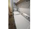 Convenient laundry area with a washer, dryer, water heater, and shelving at 110 Kasey Dr, Orlando, FL 32807