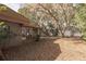 A view of the backyard, with lots of trees and a glimpse of the house at 1101 N Valencia Ave, Howey In The Hills, FL 34737