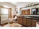 Bathroom featuring a tiled shower-tub, mirror, and wooden cabinets at 1101 N Valencia Ave, Howey In The Hills, FL 34737