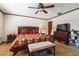 Bedroom features a bed, nightstand, bench and ceiling fan at 1101 N Valencia Ave, Howey In The Hills, FL 34737