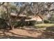 Landscaped yard featuring mature trees and bushes surrounds this single story brick home at 1101 N Valencia Ave, Howey In The Hills, FL 34737