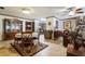 Cozy living room featuring hardwood floors, a dining table, and elegant wooden furniture at 1101 N Valencia Ave, Howey In The Hills, FL 34737