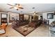 Spacious living room with plush sofas, a patterned rug, and decorative built-in shelving at 1101 N Valencia Ave, Howey In The Hills, FL 34737