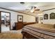 Comfortable main bedroom featuring a ceiling fan and multiple entryways at 1101 N Valencia Ave, Howey In The Hills, FL 34737