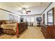 Main bedroom with a large window, a ceiling fan, and carpeted floors at 1101 N Valencia Ave, Howey In The Hills, FL 34737