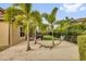 Backyard with a hammock between palm trees and view of the putting green and patio at 11507 Center Lake Dr, Windermere, FL 34786