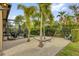 Backyard area with sand, palm trees, hammock and screened patio with dining set at 11507 Center Lake Dr, Windermere, FL 34786