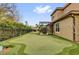 Private backyard featuring a custom putting green, screened patio, and lush landscaping for outdoor enjoyment at 11507 Center Lake Dr, Windermere, FL 34786