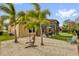 Backyard with sand area, hammock between palm trees, patio and putting green at 11507 Center Lake Dr, Windermere, FL 34786