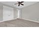 Bedroom with neutral carpet, ceiling fan, and large closet providing ample storage at 11507 Center Lake Dr, Windermere, FL 34786