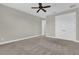 Spacious bedroom featuring plush carpet, ceiling fan, and a large closet at 11507 Center Lake Dr, Windermere, FL 34786