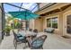 This covered patio features an umbrella, ceiling fan, and outdoor seating at 11507 Center Lake Dr, Windermere, FL 34786