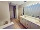 Bathroom with a long vanity, a tub, and access to the closet at 14410 Sw 79Th Ter, Ocala, FL 34473