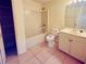 Bathroom featuring a shower-tub combo, toilet, vanity, and tile flooring at 14410 Sw 79Th Ter, Ocala, FL 34473