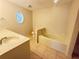 Bathroom with a tub and shower combo, separate toilet, and oval window at 14410 Sw 79Th Ter, Ocala, FL 34473