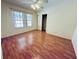 Bright bedroom with sleek wood floors, closet, and natural light from double windows at 14410 Sw 79Th Ter, Ocala, FL 34473