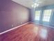 Bedroom with laminate flooring, plum-colored walls, natural light from the two windows at 14410 Sw 79Th Ter, Ocala, FL 34473