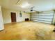 Spacious garage with a door, overhead lighting, and an automatic garage door opener at 14410 Sw 79Th Ter, Ocala, FL 34473