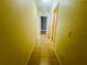 Long hallway featuring tile floors and textured walls leading to other rooms in the home at 14410 Sw 79Th Ter, Ocala, FL 34473