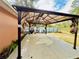 Outdoor patio featuring a stylish pergola with draped curtains on a concrete slab, offering a shaded relaxation space at 14410 Sw 79Th Ter, Ocala, FL 34473