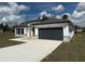 Charming home with gray accents, modern design, and a well-manicured lawn at 171 Marion Oaks Trl, Ocala, FL 34473