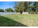 Fenced backyard with green grass and mature trees at 1809 Simonton Ave, Orlando, FL 32806