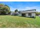 Backyard with green grass and back exterior of the home at 1809 Simonton Ave, Orlando, FL 32806