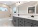 New bathroom featuring a gray double vanity, white countertop, modern fixtures, and a separate tub at 1809 Simonton Ave, Orlando, FL 32806