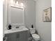 Powder room featuring a stylish vanity, contemporary fixtures, and elegant wall art at 1809 Simonton Ave, Orlando, FL 32806