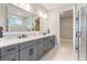 Bathroom boasts a large vanity with double sinks, quartz countertops, and gray cabinetry at 1809 Simonton Ave, Orlando, FL 32806