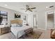 Inviting main bedroom with a ceiling fan, natural light, and a connecting bath and stairs at 1809 Simonton Ave, Orlando, FL 32806