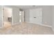 Carpeted bedroom with closet and bathroom entrances; neutral color palette at 1809 Simonton Ave, Orlando, FL 32806