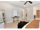 Bedroom showcases light wood flooring and a view into the stairway landing and bathroom at 1809 Simonton Ave, Orlando, FL 32806