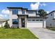 Stunning two-story home featuring a stone pillar entrance and a modern two-car garage at 1809 Simonton Ave, Orlando, FL 32806