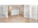 Hallway with light wood floors leading to doorways to other rooms at 1809 Simonton Ave, Orlando, FL 32806