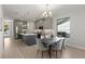 Open-concept kitchen and dining area with gray cabinets, stainless steel appliances, and hardwood floors at 1809 Simonton Ave, Orlando, FL 32806