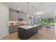 Modern kitchen with gray cabinets, large center island, and stainless steel appliances overlooks the dining and living areas at 1809 Simonton Ave, Orlando, FL 32806