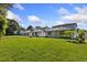 Back exterior view of a home showing lawn space, rear elevation, and trees surrounding the property at 1811 Simonton Ave, Orlando, FL 32806