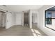 Bright hallway featuring wood floors, a barn door, and natural light from a window overlooking the exterior at 1811 Simonton Ave, Orlando, FL 32806