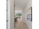 Hallway view with a glimpse of a modern kitchen and dining area with sliding glass doors at 1811 Simonton Ave, Orlando, FL 32806